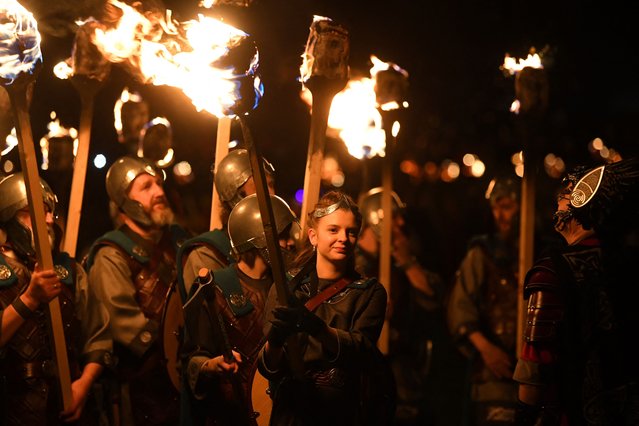 Members of the Up Helly Aa “Jarl Squad” parade through the streets of in Lerwick, Shetland Islands on January 30, 2024 during the Up Helly Aa festival later in the day. Up Helly Aa celebrates the influence of the Scandinavian Vikings in the Shetland Islands and culminates with up to 1,000 “guizers” (men in costume) throwing flaming torches into their Viking longboat and setting it alight later in the evening. (Photo by Andy Buchanan/AFP Photo)