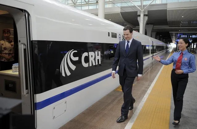 Britain's Chancellor of the Exchequer George Osborne (L) walks towards a Chinese high-speed built train as he visits the Chengdu East Railway Station in Chengdu, Sichuan province, China, September 24, 2015. (Photo by Reuters/China Daily)