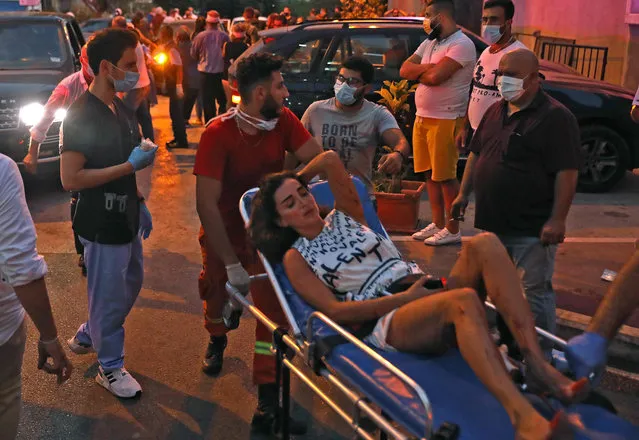 A woman is wheeled into a hospital following an explosion in the Lebanese capital Beirut on August 4, 2020. (Photo by Ibrahim Amro/AFP Photo)