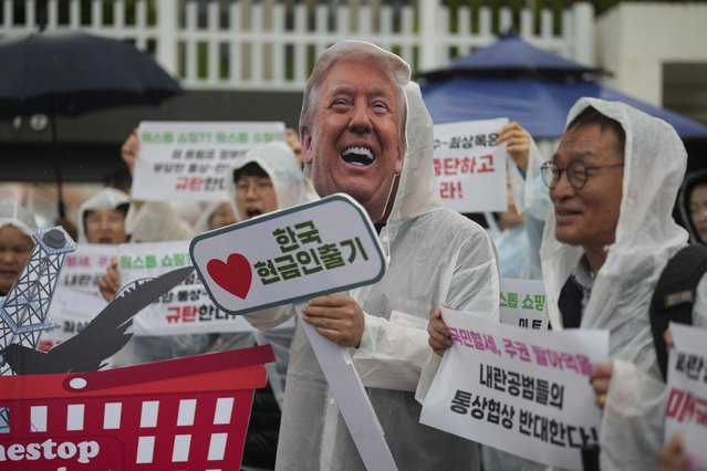 A protester wearing mask of U.S. President Donald Trump, center, attends a news conference against Trump's tariffs policy and demand South Korean acting President Han Duck-soo and Finance Minister Choi Sang-mok to resign, in Seoul, South Korea, Tuesday, April 22, 2025. (Photo by Lee Jin-man/AP Photo)