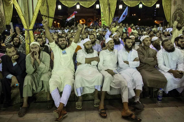 In this Tuesday, October 6, 2015 photo, Salafists shout during a campaign rally of the Al-Nour party in Alexandria, Egypt, ahead of Egyptian parliamentary elections that start later this month. Al-Nour, a group who adhere to an ultraconservative sect of Islam, came in second only to the now-banned Muslim Brotherhood party in the previous parliamentary election. Al-Nour backed the military led ouster of Muslim brotherhood president Muhammed Morsi in 2013. (Photo by Eman Helal/AP Photo)