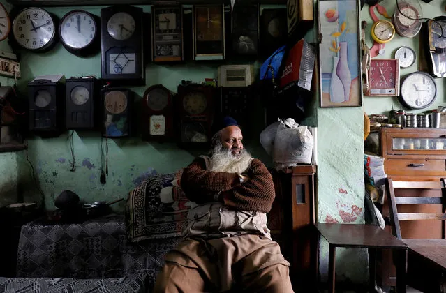 A man sits inside his 42-year old shop of antique clocks in the old quarters of Delhi, India, January 24, 2018. (Photo by Saumya Khandelwal/Reuters)