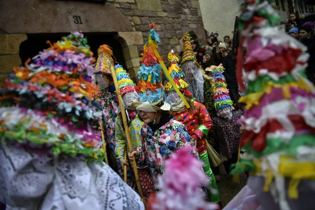 A group of participants called “Txatxus” take part in the ancient rural carnival in the small Pyrenees village of Lantz, northern Spain, Sunday, February11, 2018. The carnival is a long-standing rural tradition in which the forces of good and evil confront each other in a symbolic battle. From Sunday to Tuesday, during carnival week, in the little village of Lantz, the legendarily evil bandit Miel Otxin, represented by a doll fill of straw, is imprisoned and sentenced to death by fire. (Photo by Alvaro Barrientos/AP Photo)