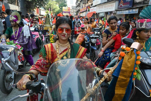 Women dressed in traditional attire ride motorcycles during a procession to mark “Gudi Padwa” or the Maharashtrian New Year, in Mumbai on April 9, 2024. (Photo by Indranil Mukherjee/AFP Photo)