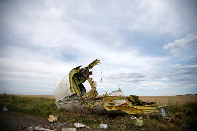 A part of the wreckage is seen at the crash site of the Malaysia Airlines Flight MH17 near the village of Hrabove (Grabovo), in the Donetsk region July 21, 2014. (Photo by Maxim Zmeyev/Reuters)