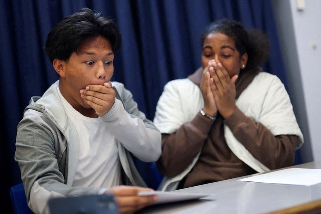 Joshua Boado, 16, and Rahnai Henricus, 16, students at Harris Academy Merton, react as they collect their GCSE results, in London, Britain on August 21, 2025. (Photo by Hannah McKay/Reuters)