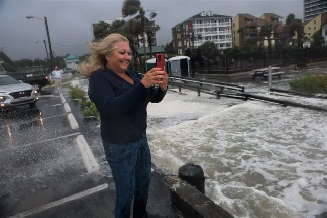 Debbi Cole photographs the ocean while Hurricane Ian makes an impact on the South Carolina coast of Myrtle Beach on September 30, 2022. (Photo by Melissa Sue Gerrits for The Washington Post)