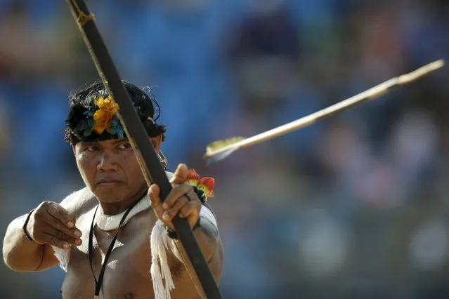 An indigenous man from Kuikuru fires an arrow during the bow-and-arrow competition at the first World Games for Indigenous Peoples in Palmas, Brazil, October 28, 2015. (Photo by Ueslei Marcelino/Reuters)