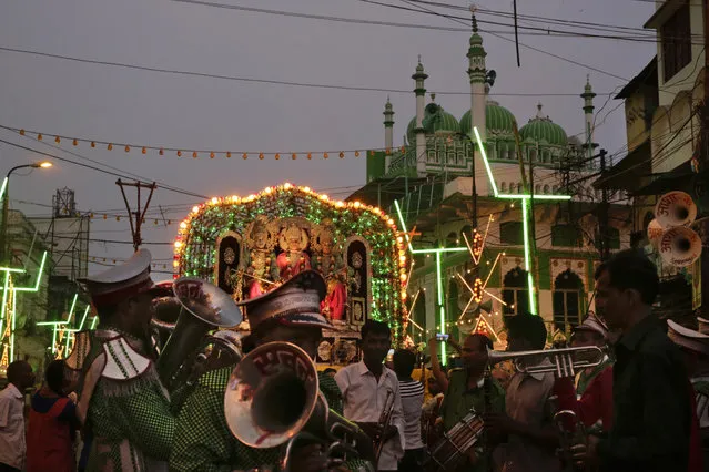 Indians gather during a religious procession ahead of Dussehra festival in Allahabad, India, early Tuesday, October 4, 2016. The Hindu festival celebrates the victory of good over evil. (Photo by Rajesh Kumar Singh/AP Photo)