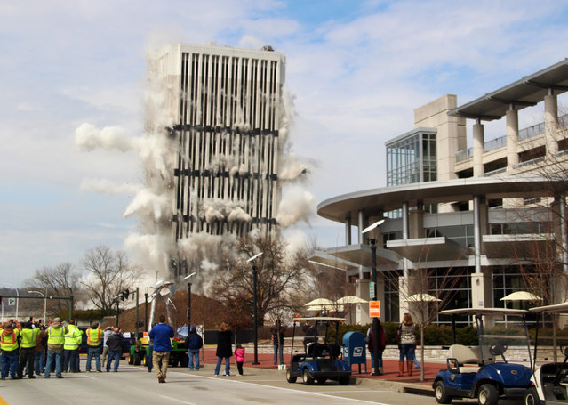 The 28-story Capital Plaza Tower falls during a controlled demolition in Frankfort, Ky., on Sunday, March 11, 2018. Built in 1972, the former state government office building was demolished to make way for a new five-story building and parking garage. (Photo by Adam Beam/AP Photo)