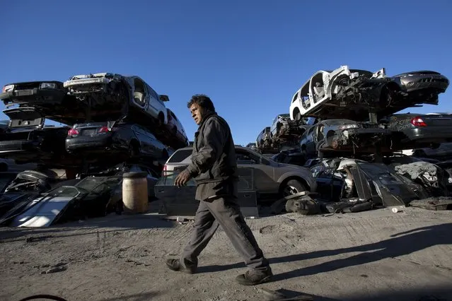 A worker walks through a junkyard in the Willets Point area of Queens in New York October 30, 2015. (Photo by Andrew Kelly/Reuters)