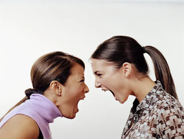 Two young female business associates yelling at each other, profile. (Photo by Stewart Cohen/Getty Images)