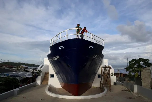 Children play on top of a cargo ship that was swept during the onslaught of Typhoon Haiyan in Tacloban city in central Philippines November 2, 2015, ahead of the second anniversary of a devastating typhoon that killed more than 6,000 people in central Philippines. The front part of the ship was retained in the area and made into a memorial and will be inaugurated on November 8 to commemorate the second anniversary of Typhoon Haiyan. (Photo by Erik De Castro/Reuters)
