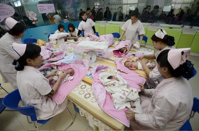 Infants undergo a daily medical examination at a maternal and child health care hospital in Taiyuan, Shanxi province, China, in this December 3, 2012 file photo. China will ease family planning restrictions to allow all couples to have two children after decades of the strict one-child policy, the ruling Communist Party said on October 29, 2015, a move aimed at alleviating demographic strains on the economy. (Photo by Reuters/Stringer)