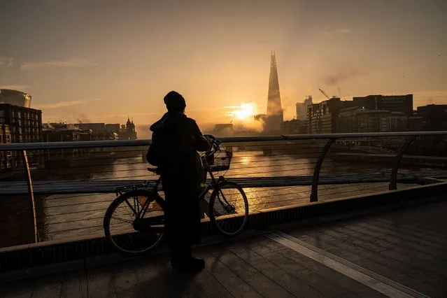 The sun rises behind the Shard from Millennium Bridge, London on Tuesday, February 7, 2023. (Photo by Aaron Chown/PA Images via Getty Images)