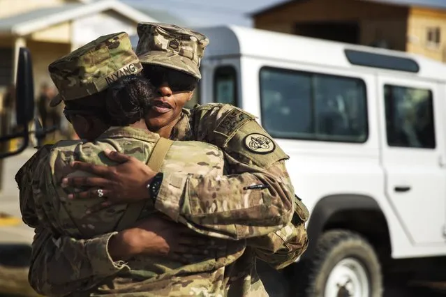 U.S. soldiers from the 3rd Cavalry Regiment embrace after attending a memorial for Specialist Wyatt Martin and Sergeant First Class Ramon Morris at Bagram Air Field in the Parwan province of Afghanistan December 23, 2014. Specialist Martin and Sergeant First Class Ramon were killed on December 12 by an improvised explosive device while on patrol near Bagram Air Field. (Photo by Lucas Jackson/Reuters)