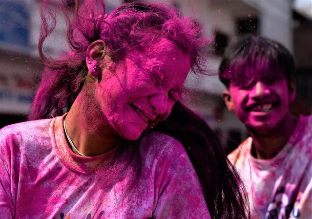A girl reacts while celebrating Holi, the Festival of Colours in Kathmandu, Nepal on March 06, 2023. (Photo by Monika Malla/Reuters)