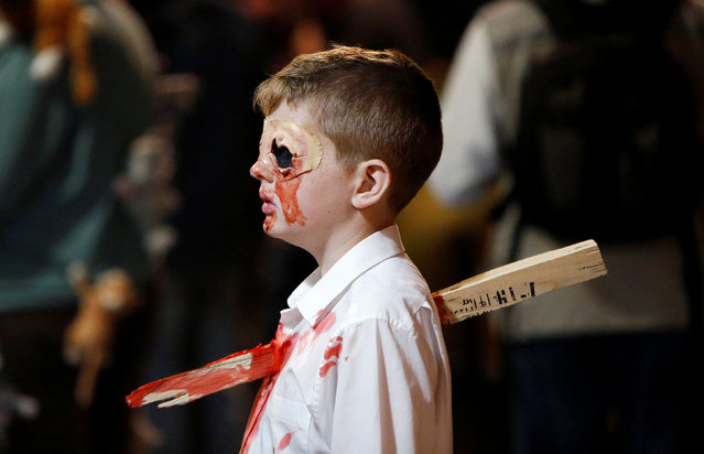 A little boy Zombie with a stake through his chest takes part in the annual Silver Spring Zombie Walk in Silver Spring, Maryland, U.S., October 29, 2016. (Photo by Gary Cameron/Reuters)