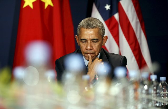 U.S. President Barack Obama listens to remarks by Chinese President Xi Jinping during their meeting at the start of the two-week climate summit in Paris November 30, 2015. (Photo by Kevin Lamarque/Reuters)