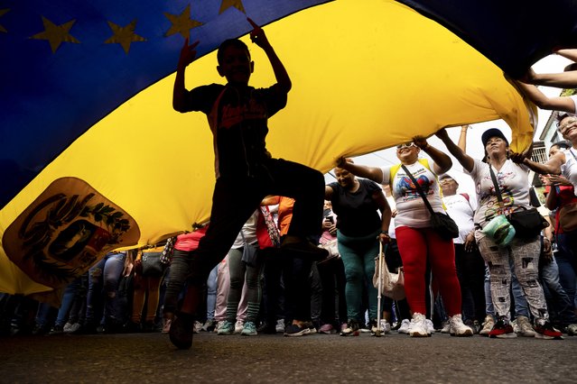 People participate in a demonstration in Caracas, Venezuela, 28 October 2025. Chavistas marched in defense of Venezuela's sovereignty and against Trinidad and Tobago Prime Minister Kamla Persad-Bissessar after the neighboring island nation received a U.S. Navy destroyer for military exercises on Sunday amid the U.S. deployment in the Caribbean. (Photo by Miguel Gutiérrez/EPA)