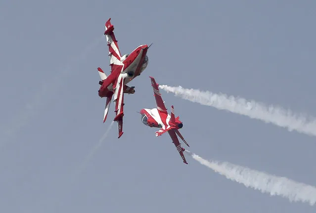 Indian Air Force Suryakiran aircrafts perform an aerobatic maneuver during rehearsals ahead of Aero India 2021 at Yelahanka air base in Bengaluru, India, Tuesday, February 2, 2021. Aero India is a biennial event with flying demonstrations by stunt teams and militaries and commercial pavilions where aviation companies display their products and technology. (Photo by Aijaz Rahi/AP Photo)