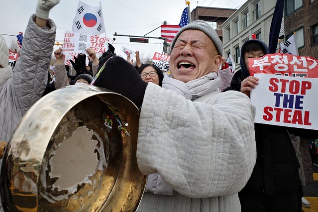 Supporters of impeached South Korean president Yoon Suk Yeol react during a rally near his residence in Seoul on January 6, 2025. South Korean investigators trying to arrest suspended President Yoon Suk Yeol have asked for an extension to the warrant that expires on January 6, with the embattled leader holed up in his residence. (Photo by Anthony Wallace/AFP Photo)