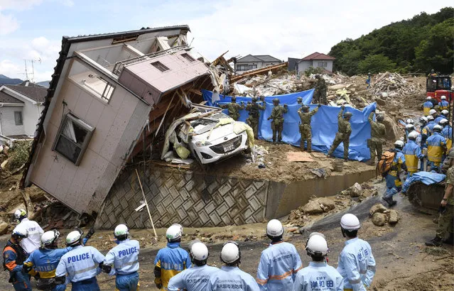 Rescuers conduct a search operation for missing persons in Kumano town, Hiroshima prefecture, western Japan Monday, July 9, 2018. People prepared for risky search and cleanup efforts in southwestern Japan on Monday, where several days of heavy rainfall had set off flooding and landslides in a widespread area. (Photo by Sadayuki Goto/Kyodo News via AP Photo)