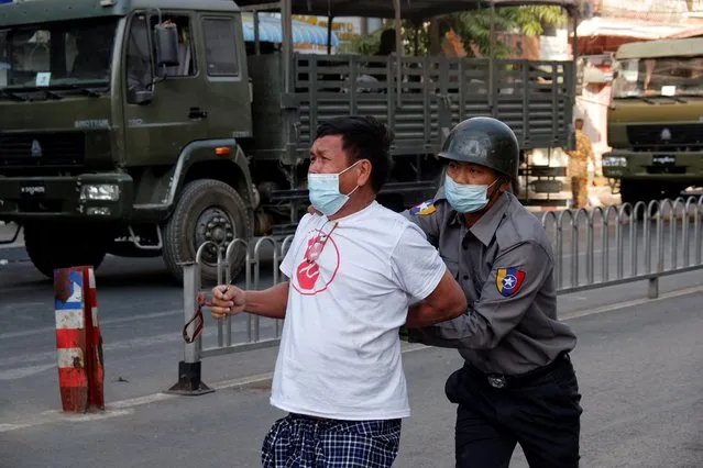 Police arrest a protester demonstrating against the military coup in Mandalay on February 15, 2021. (Photo by Reuters/Stringer)
