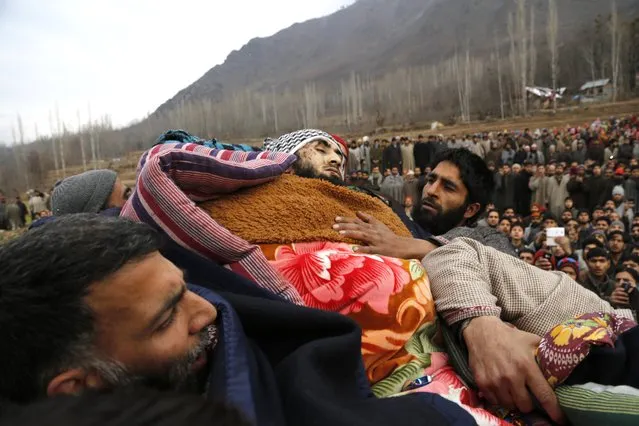 Kashmiri Muslim villagers carry the body of Abid Ahmed Khan, a suspected local militant commander, during his funeral procession in Handora, some 40 kilometers (25 miles) south of Srinagar, India, Wednesday, January 28, 2015. A brief gun battle between Indian government forces and suspected rebels on Tuesday killed two rebels and two troops in the disputed Kashmir region, police said. (Photo by Mukhtar Khan/AP Photo)