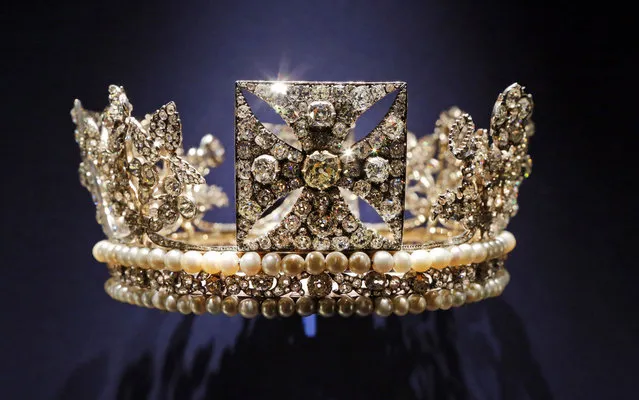 In this Thursday, July 25, 2013 photo, the diamond diadem, made of diamonds, pearls, silver and gold, worn by Britain's Queen Elizabeth II on her way from Buckingham Palace to Westminster Abbey for her 1953 Coronation and during the first part of the ceremony, is displayed at the exhibition “The Queen's Coronation 1953” at Buckingham Palace in central London. This year marks the 60th anniversary of the coronation and to celebrate this anniversary, a special exhibition brings together an array of the dress, uniform and robes worn for the historic event. Paintings, objects and works of art relating to the Coronation will also be on display from July 27 until Sept. 29, 2013. (Photo by Lefteris Pitarakis/AP Photo)