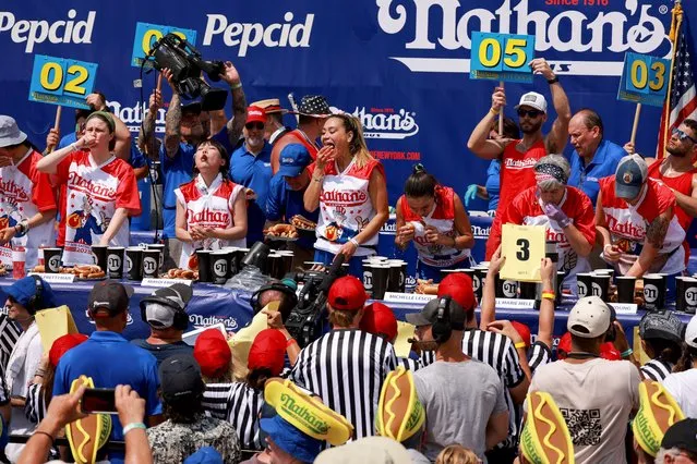 People compete in the 2023 Nathan's Famous Fourth of July International Hot Dog Eating Contest at Coney Island in New York City, U.S., July 4, 2023. (Photo by Amr Alfiky/Reuters)