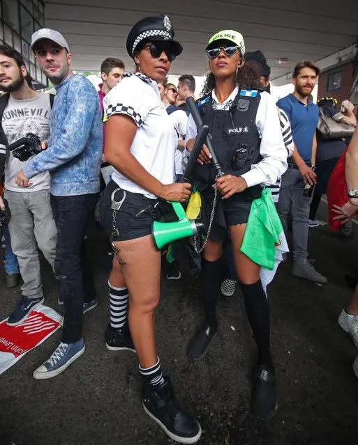 Partygoers dress up as police officers at the Notting Hill Carnival in west London, Britain on August 27, 2018. (Photo by Yui Mok/PA Images via Getty Images)