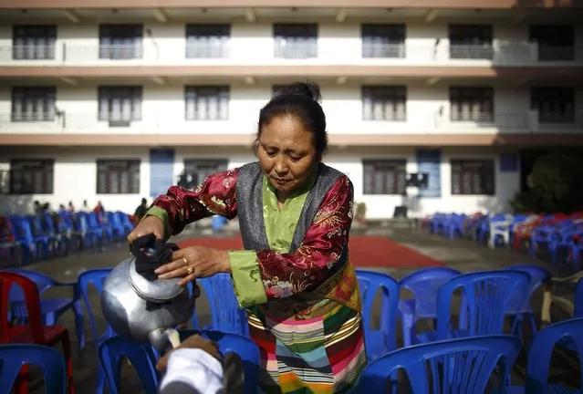 A Tibetan woman offers butter tea to a guest during the function organised to mark Losar or the Tibetan New Year at Tibetan Refugee Camp in Lalitpur February 19, 2015. (Photo by Navesh Chitrakar/Reuters)
