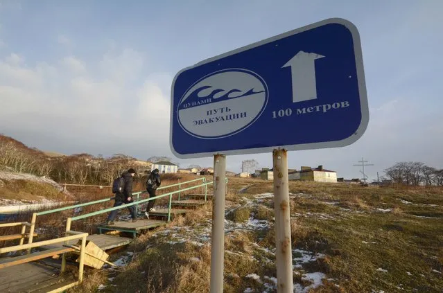 A sign, which reads “Tsunami. Evacuation route. 100 metres”, is on display in Krabozavodskoye settlement on the Island of Shikotan, one of four islands known as the Southern Kuriles in Russia and the Northern Territories in Japan, December 19, 2016. (Photo by Yuri Maltsev/Reuters)