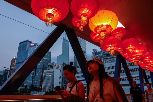 Red lanterns are seen hanging on the pedestrian footbridge as decorations for the celebration of National Day, in the financial central district of Hong Kong, China on October 3, 2023. (Photo by Tyrone Siu/Reuters)