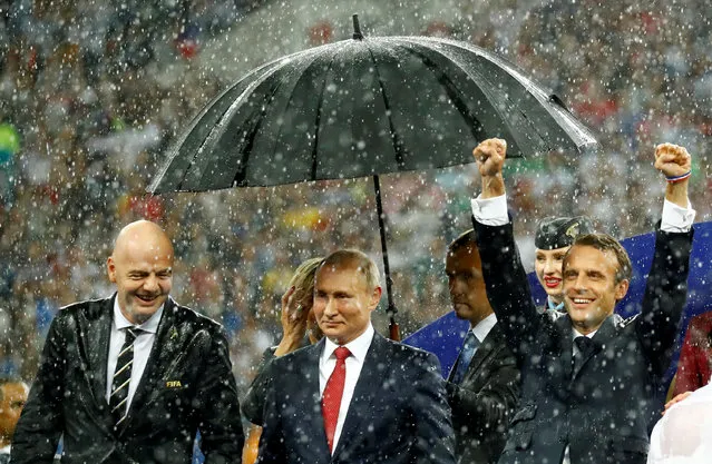 FIFA president Gianni Infantino, President of Russia Vladimir Putin and President of France Emmanuel Macron during the presentation of the World Cup trophy to France, after they defeated Croatia to win the final in Moscow, July 15, 2018. (Photo by Kai Pfaffenbach/Reuters)