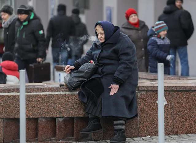 A woman smokes as she rests in central Kiev, Ukraine January 5, 2017. (Photo by Gleb Garanich/Reuters)
