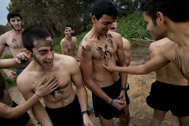 In this Friday, February 13, 2015 photo, Israeli high-school seniors preparing to join the Israeli military later this year take part in a privately run training camp for military combat fitness near Yakum, central Israel. (Photo by Oded Balilty/AP Photo)