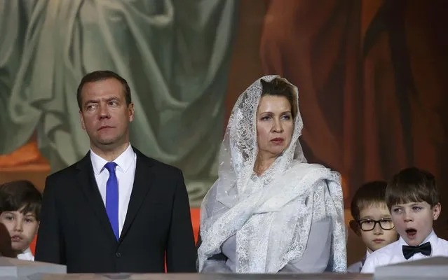 Russian Prime Minister Dmitry Medvedev and his wife Svetlana attend a service on Orthodox Christmas at the Christ the Saviour Cathedral in Moscow, Russia January 6, 2017. (Photo by Sergei Karpukhin/Reuters)