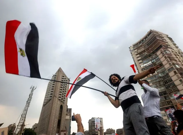 Supporters of Egyptian President Abdel Fattah al-Sisi wave flags during a rally to back his candidacy in the presidential elections in December, at Al Galaa Square in the Dokki district of Giza, Egypt on October 2, 2023. (Photo by Amr Abdallah Dalsh/Reuters)