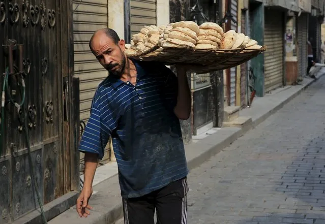 A man carries bread bought from a bakery near rows of closed shops at a popular tourist area in the Khan el-Khalili market, at al-Hussein and Al-Azhar districts in old Islamic Cairo, Egypt, November 12, 2015. (Photo by Amr Abdallah Dalsh/Reuters)