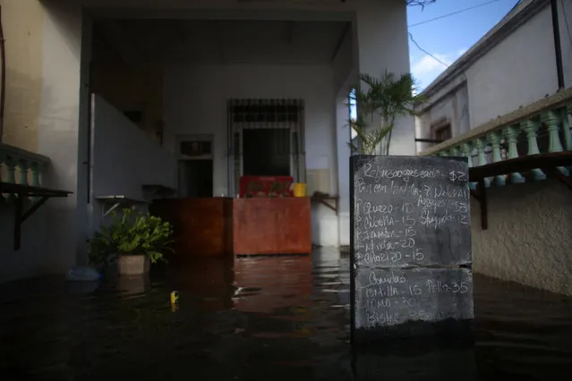 The menu of a restaurant is seen during a flood in Havana, Cuba, January 23, 2017. (Photo by Alexandre Meneghini/Reuters)
