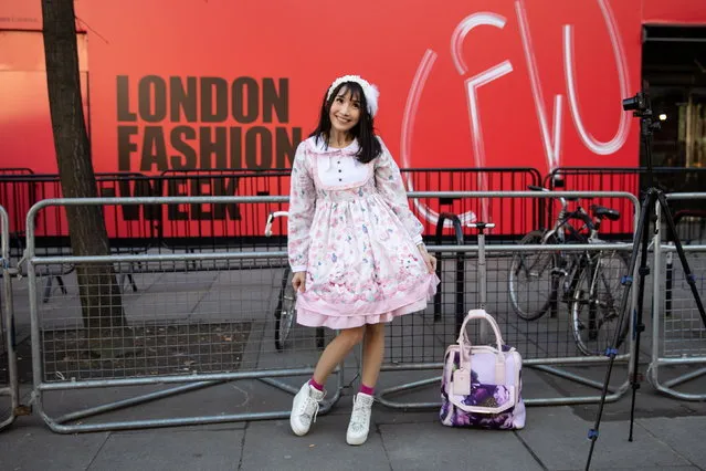 A woman poses on the street outside British Fashion Council Showspace during the London Fashion Week 2019, in Central London, Britain, 17 February 2019. (Photo by Tom Nicholson/EPA/EFE)