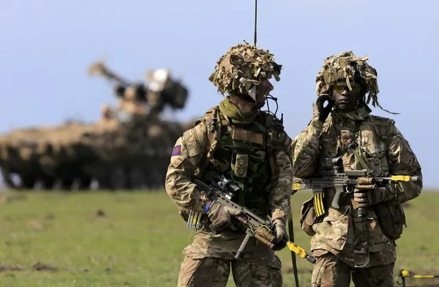 British soldiers take part in the “Wind Spring 15” military exercises at Smardan shooting range April 21, 2015. Romanian Defense Minister Mircea Dusa said the exercises, in which some 2,200 Romanian, U.S., British and Moldovan troops are participating, are part of a plan approved at NATO's 2014 summit to reinforce the eastern flank of NATO and the EU, which borders Ukraine. (Photo by Radu Sigheti/Reuters)
