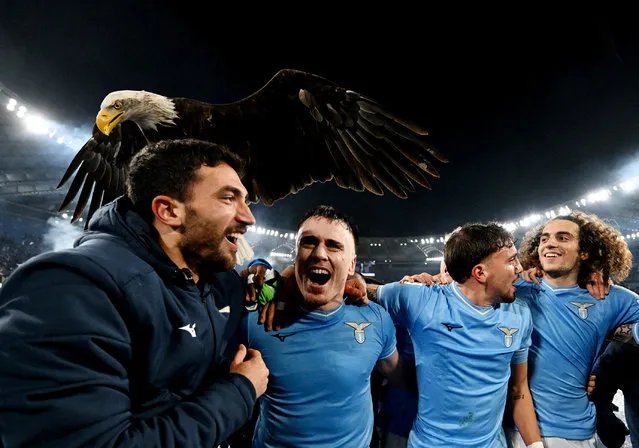 Lazio players celebrate with mascot Olympia the eagle after the match against Roma in Rome, Italy on January 10, 2024. (Photo by Alberto Lingria/Reuters)
