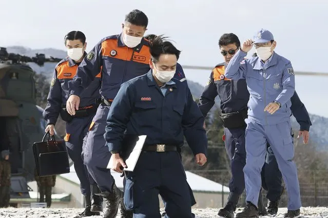 Japan's Prime Minister Fumio Kishida, right, arrives at a Japan Air Self-Defense Force sub base in Wajima, Ishikawa prefecture, Japan Saturday, January 13, 2024. Kishida visited the country's north-central region of Noto for the first time since the Jan. 1 quakes. (Photo by Kyodo News via AP Photo)