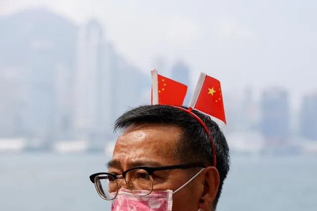 A pro-China supporter attends an event to celebrate Chinese National Day, in Hong Kong, China, October 1, 2021. (Photo by Tyrone Siu/Reuters)