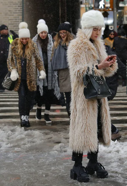 Guests wear various fur-like coats after viewing the Tadashi Shoji fashion show during Fashion Week, Thursday, February 9, 2017, in New York. (Photo by Bebeto Matthews/AP Photo)