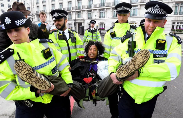 Members of the police carry a demonstrator during the Extinction Rebellion protest at the Marble Arch in London, Britain April 24, 2019. (Photo by Toby Melville/Reuters)