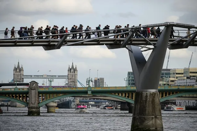 Members of the public walk across the Millennium Bridge on October 05, 2023 in London, England. The pedestrian bridge that spans the River Thames connecting the Southbank with St Paul's Cathedral was nicknamed the Wobbly Bridge when it was first unveiled. Surveys of the structure have detected excessive movement in the bridge, with urgent repairs required. It will close for three weeks for maintainence from October 14, as work is carried out to replace the synthetic membrane which separates the steel structure from its aluminium deck. (Photo by Leon Neal/Getty Images)